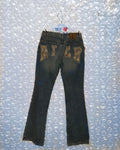 Black jeans with gold embroidery on a bubble wrap background